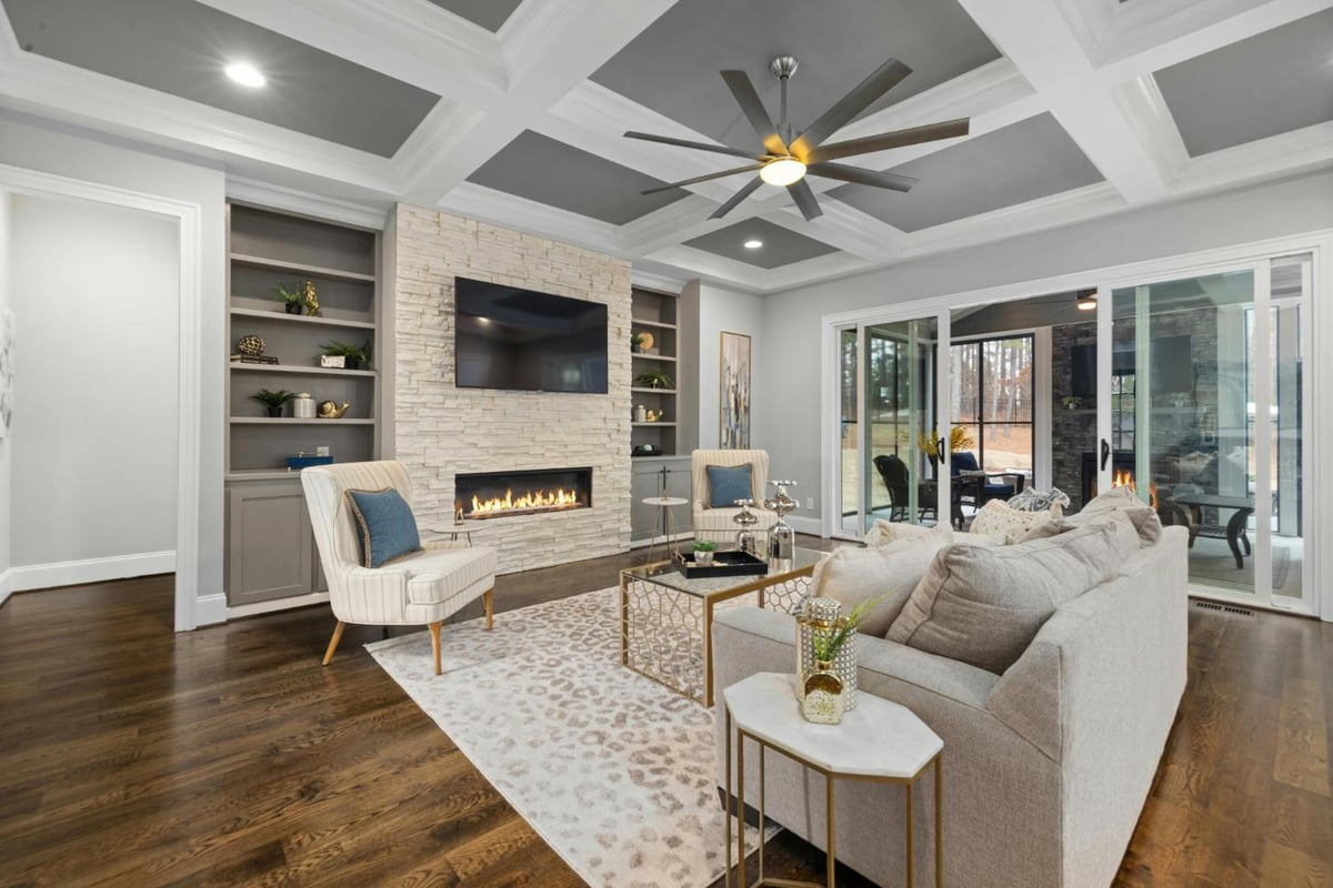 custom living room design with brick fireplace and seating area in Troutman, NC by Carolina Signature Custom Homes 