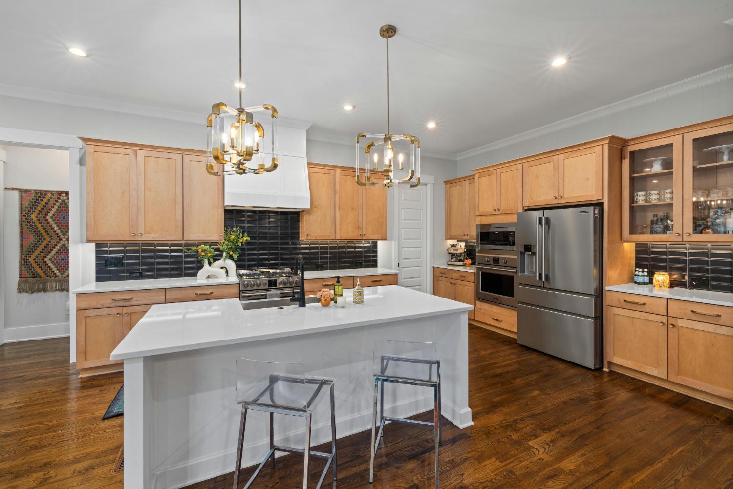 modern custom home kitchen by Carolina Signature Custom Homes featuring large island and stainless steel appliances in Troutman,-optimized