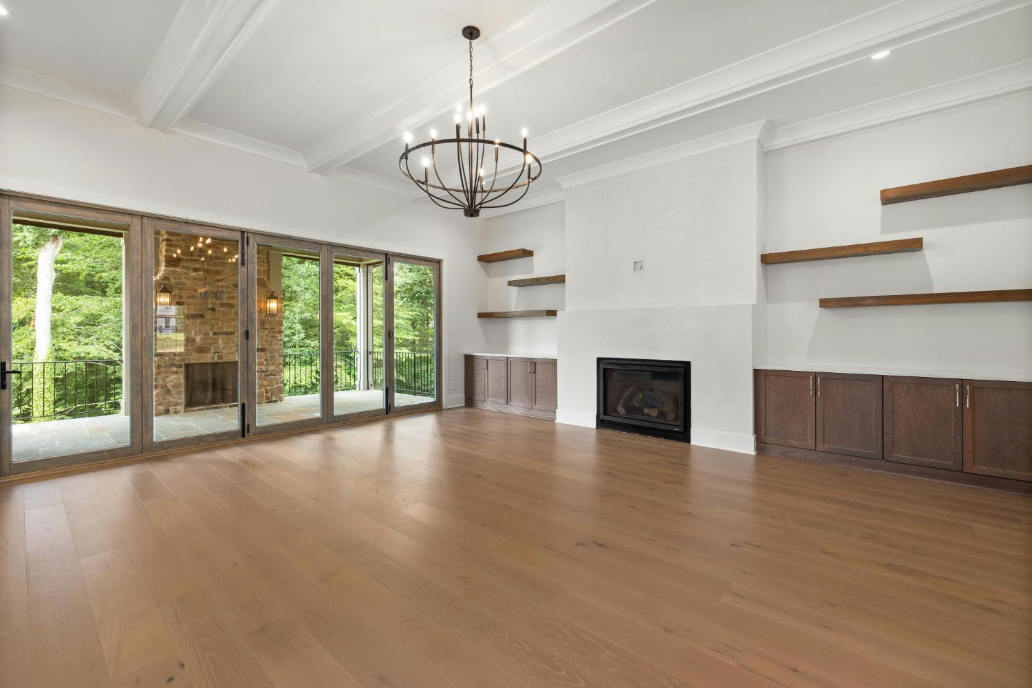 open concept living room with fireplace and large glass doors in Troutman NC by Carolina Signature Custom Homes