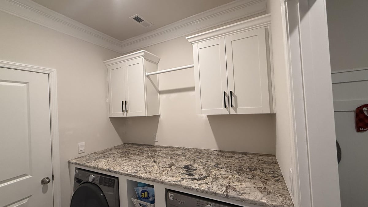 washer and dryer with organized shelving unit in Troutman, NC by Carolina Signature Custom Homes-optimized