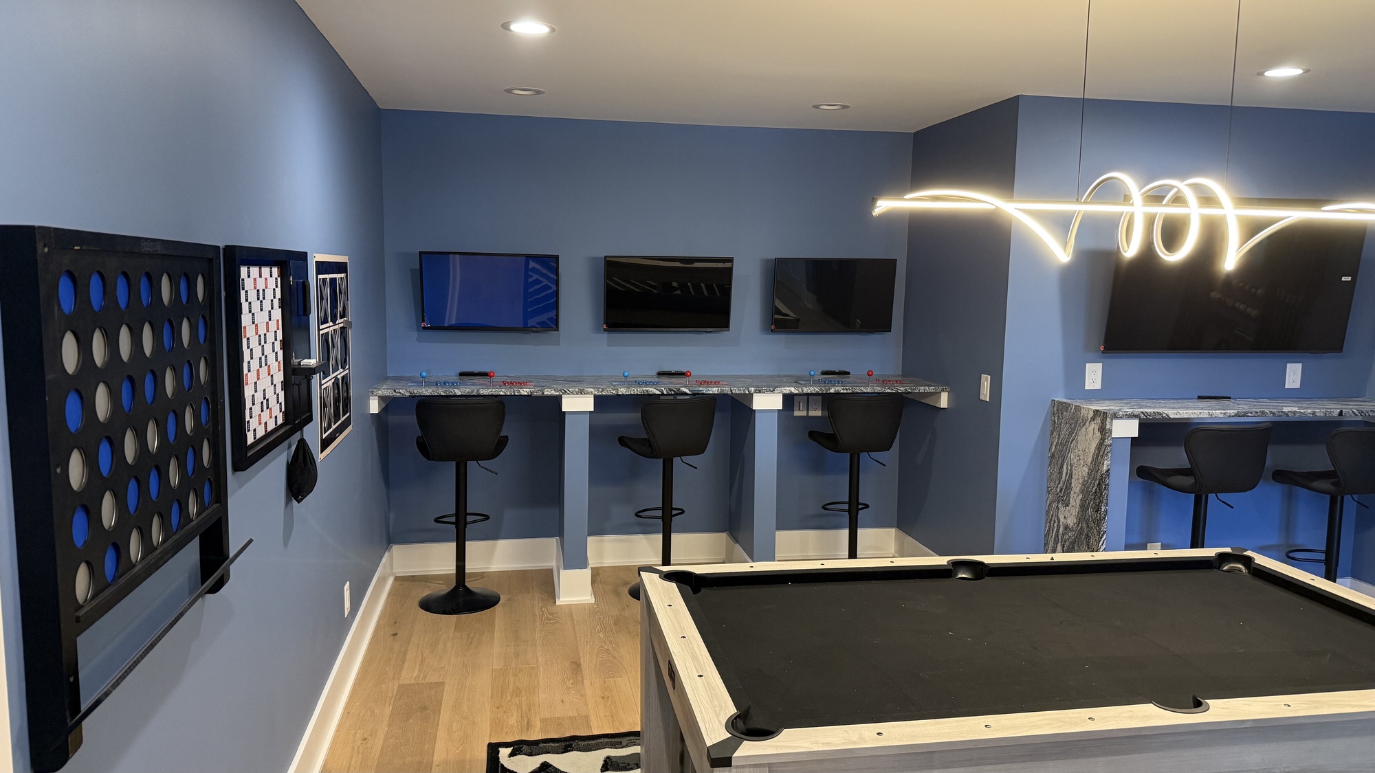 lake norman basement remodel with pool table and three gaming stations