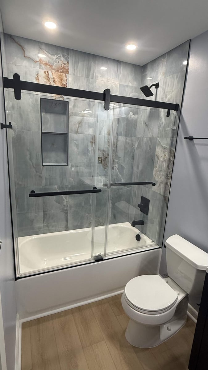 modern hall bathroom remodel with sliding glass shower doors and tile walls by Carolina Signature Custom Homes in Mooresville, N-optimized