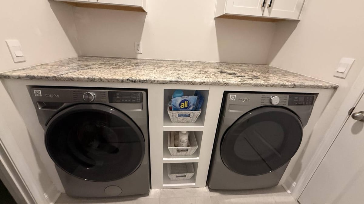 built-in laundry cabinets with appliances in Troutman, NC by Carolina Signature Custom Homes-optimized