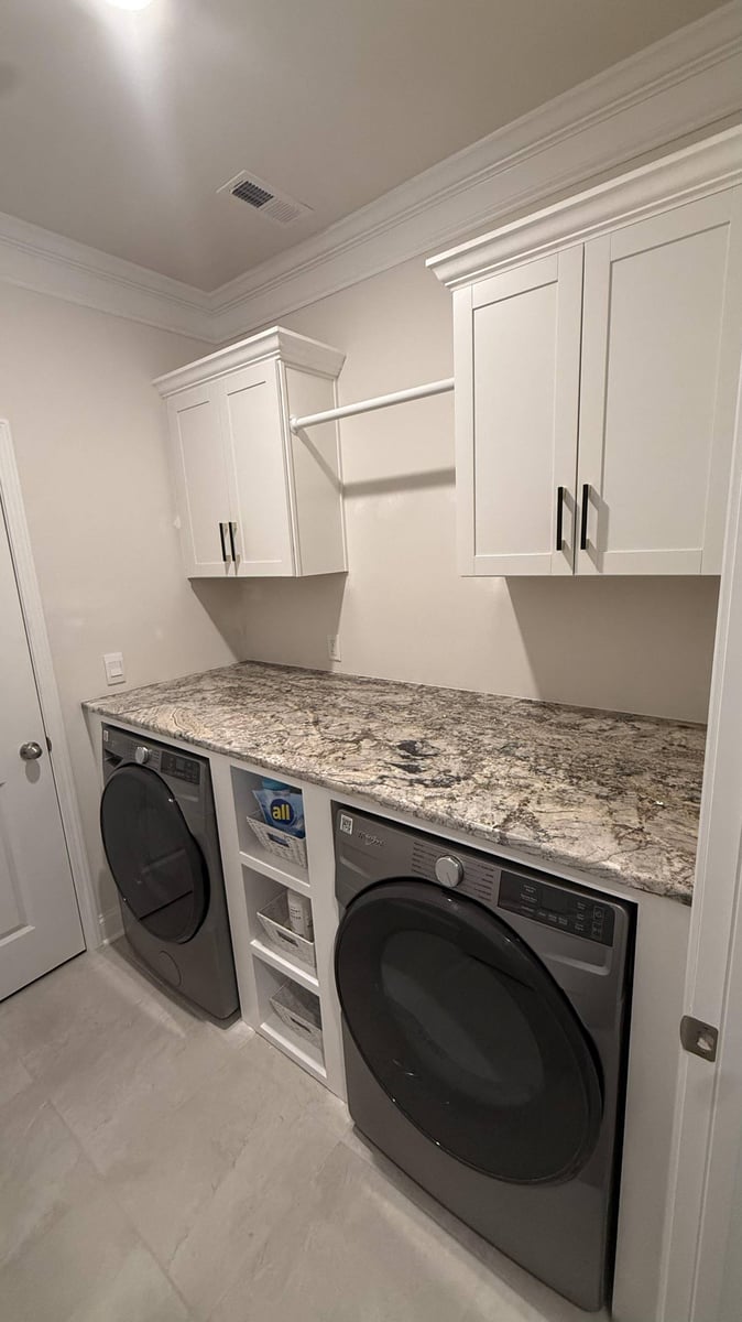 close-up of granite laundry counter and cabinetry in Troutman, NC by Carolina Signature Custom Homes-optimized