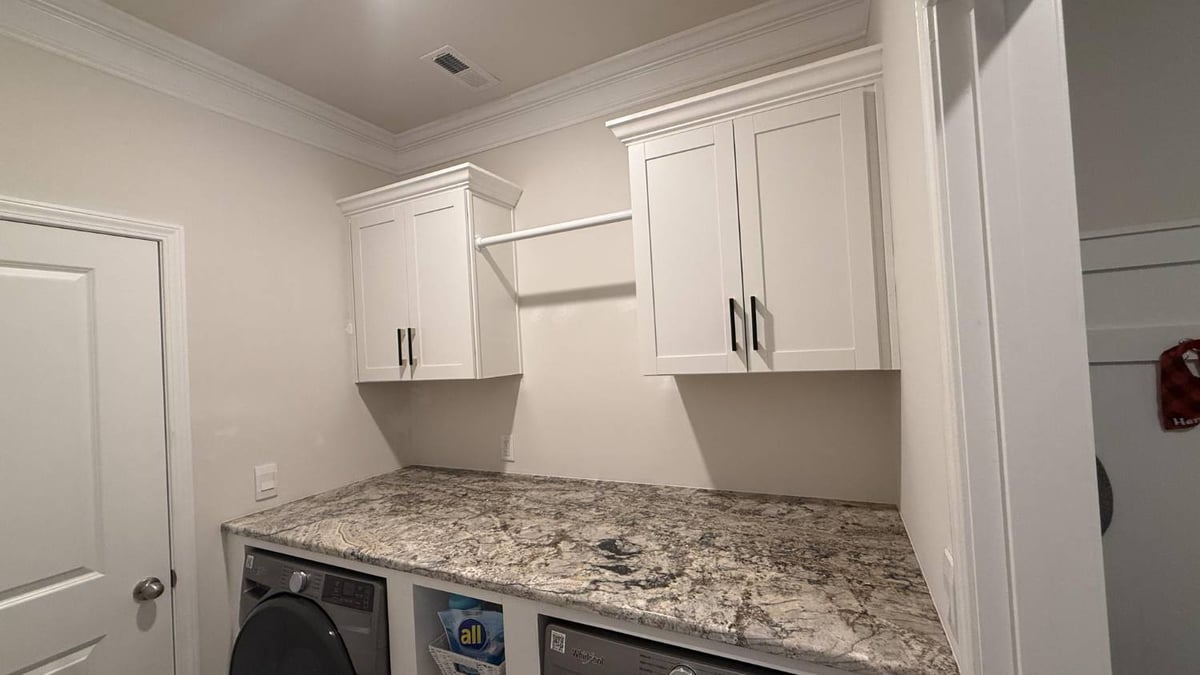 washer and dryer with organized shelving unit in Troutman, NC by Carolina Signature Custom Homes-optimized