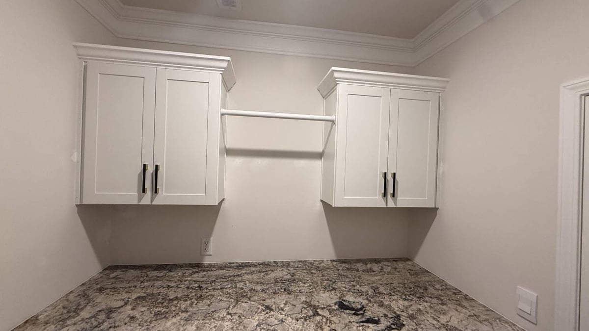 washer dryer setup with custom cabinetry and storage in Troutman, NC by Carolina Signature Custom Homes-optimized