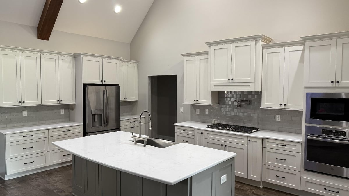 modern custom kitchen with large quartz island and shaker cabinets in Mt Ulla NC by Carolina Signature Custom Homes-optimized