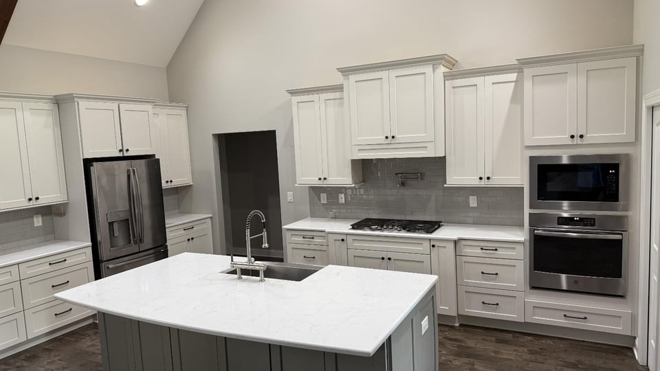 open concept kitchen with white cabinetry and island sink in Mt Ulla NC by Carolina Signature Custom Homes-optimized
