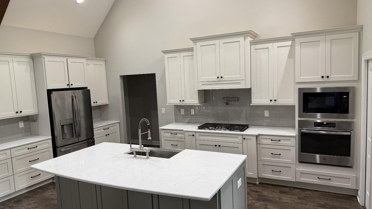 open concept kitchen with white cabinetry and island sink in Mt Ulla NC by Carolina Signature Custom Homes-optimized