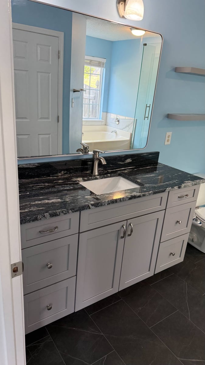 Carolina Signature Custom Homes bathroom vanity installation in Aitken Charlotte NC with granite countertop and large mirror-optimized