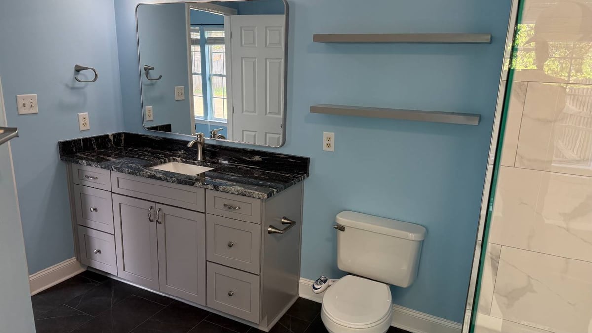 contemporary bathroom with granite countertop and glass shower by Carolina Signature Custom Homes in Aitken Charlotte NC-optimized