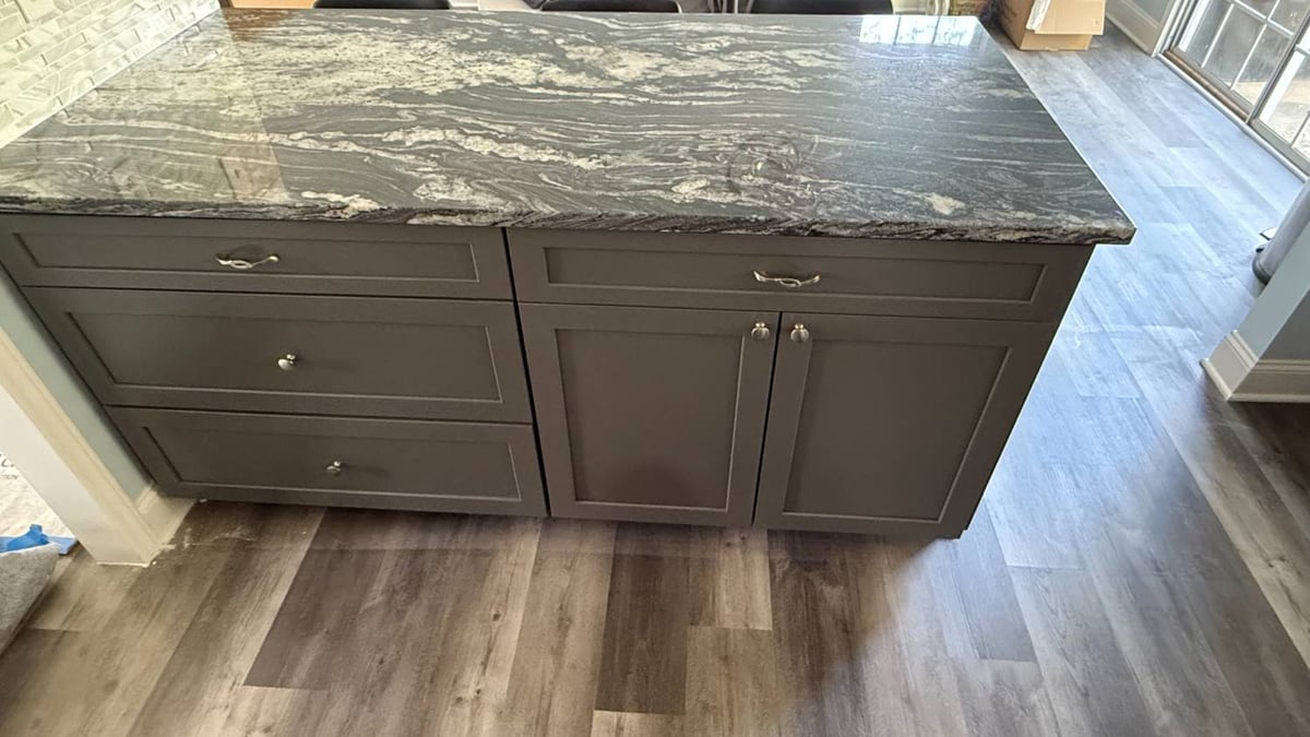 custom kitchen island with dark stone countertop and storage cabinetry in Aitken Charlotte NC by Carolina Signature Custom Homes-optimized