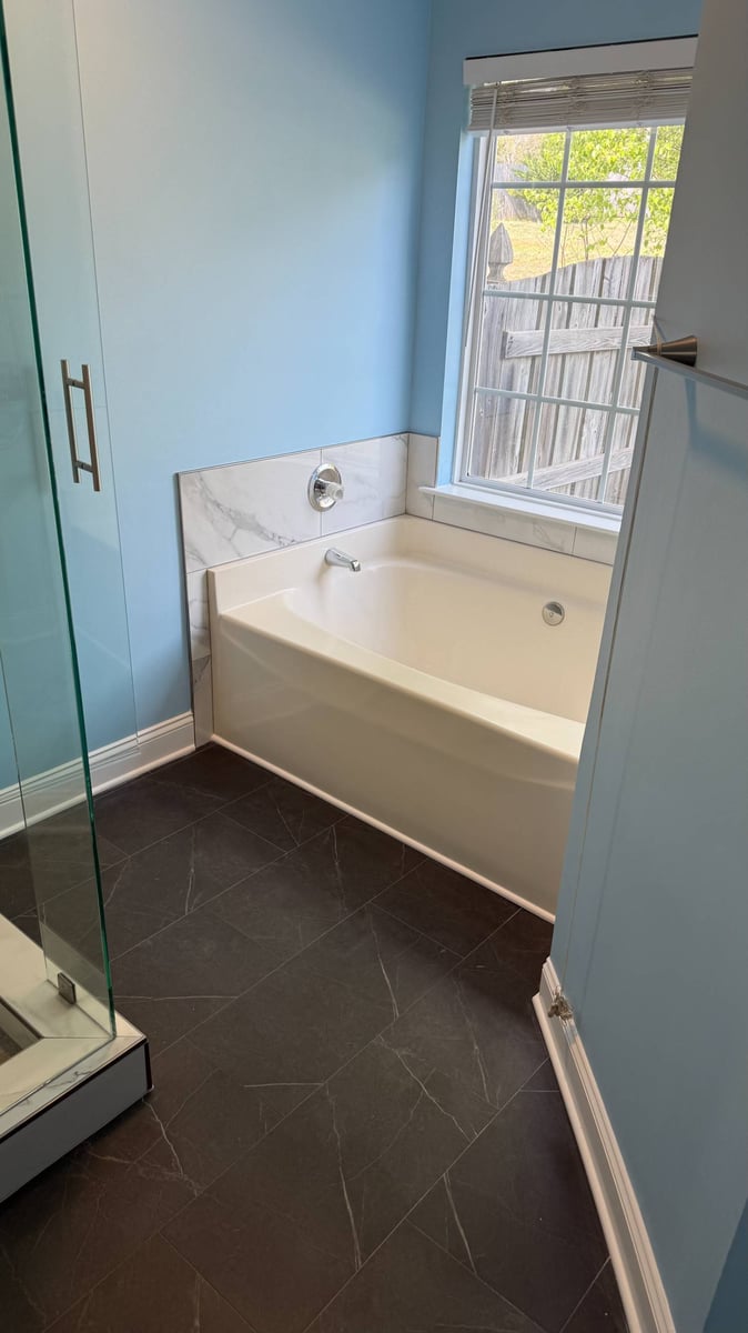 modern bathtub installation with marble tile accent in Aitken Charlotte NC by Carolina Signature Custom Homes-optimized