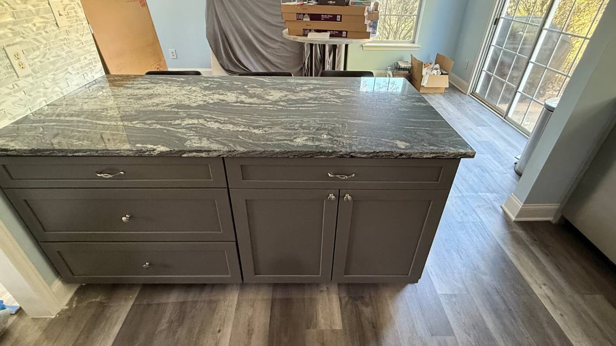 remodeled kitchen space with large island and updated flooring by Carolina Signature Custom Homes in Aitken Charlotte NC-optimized