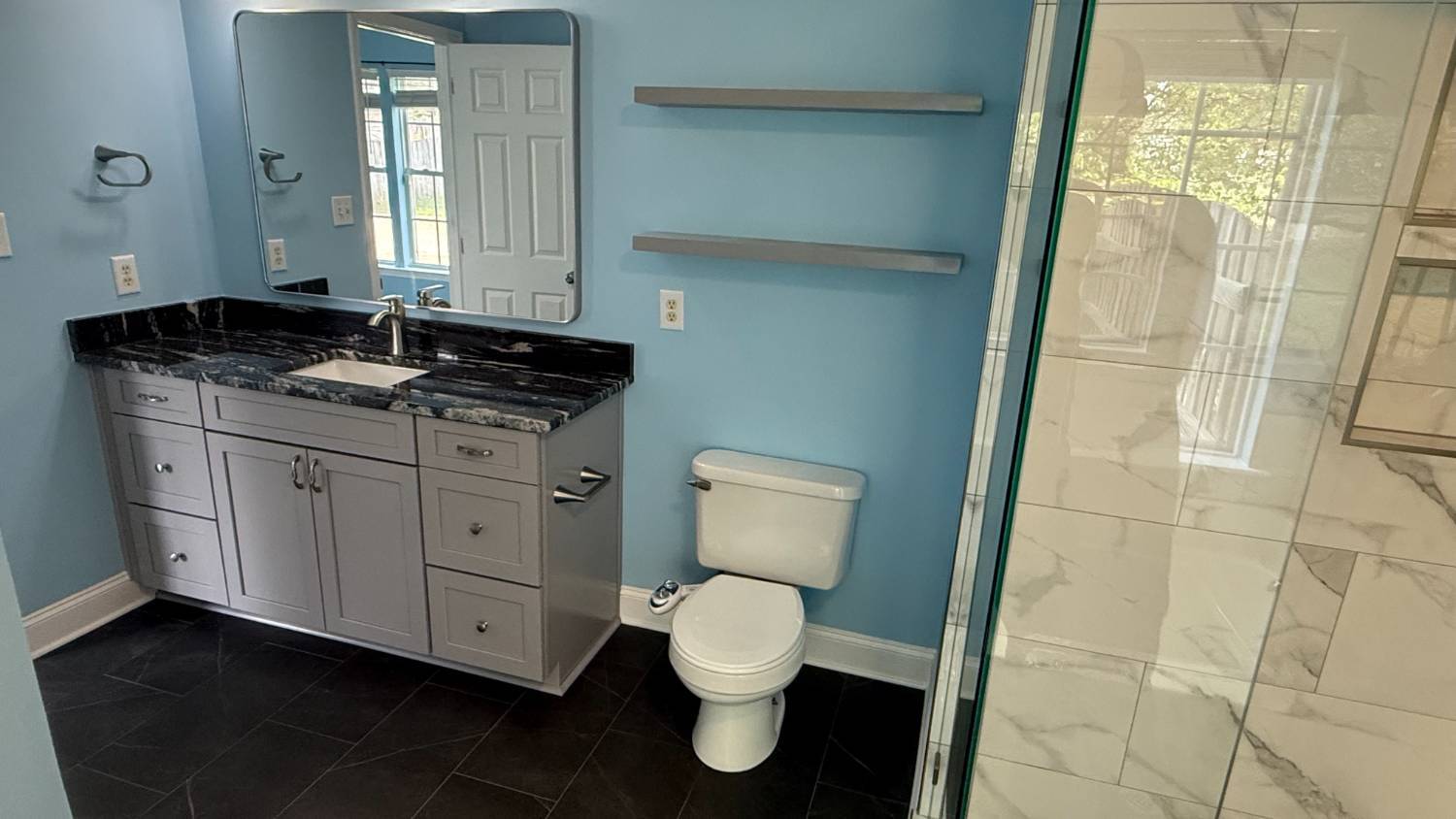 updated bathroom featuring granite vanity and glass shower in Aitken Charlotte NC by Carolina Signature Custom Homes