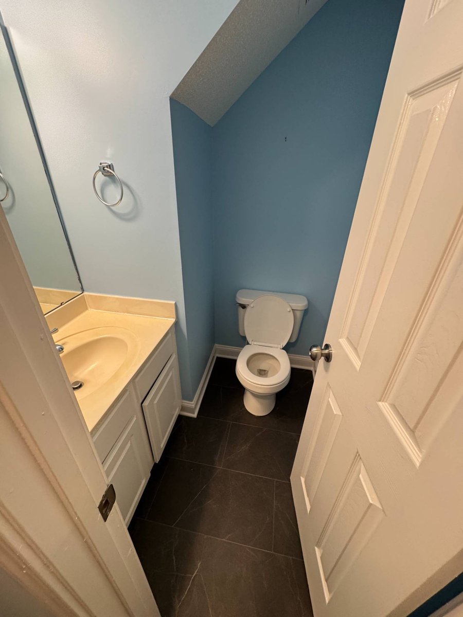 updated half bathroom with modern sink and tile floor by Carolina Signature Custom Homes in Aitken Charlotte NC-optimized