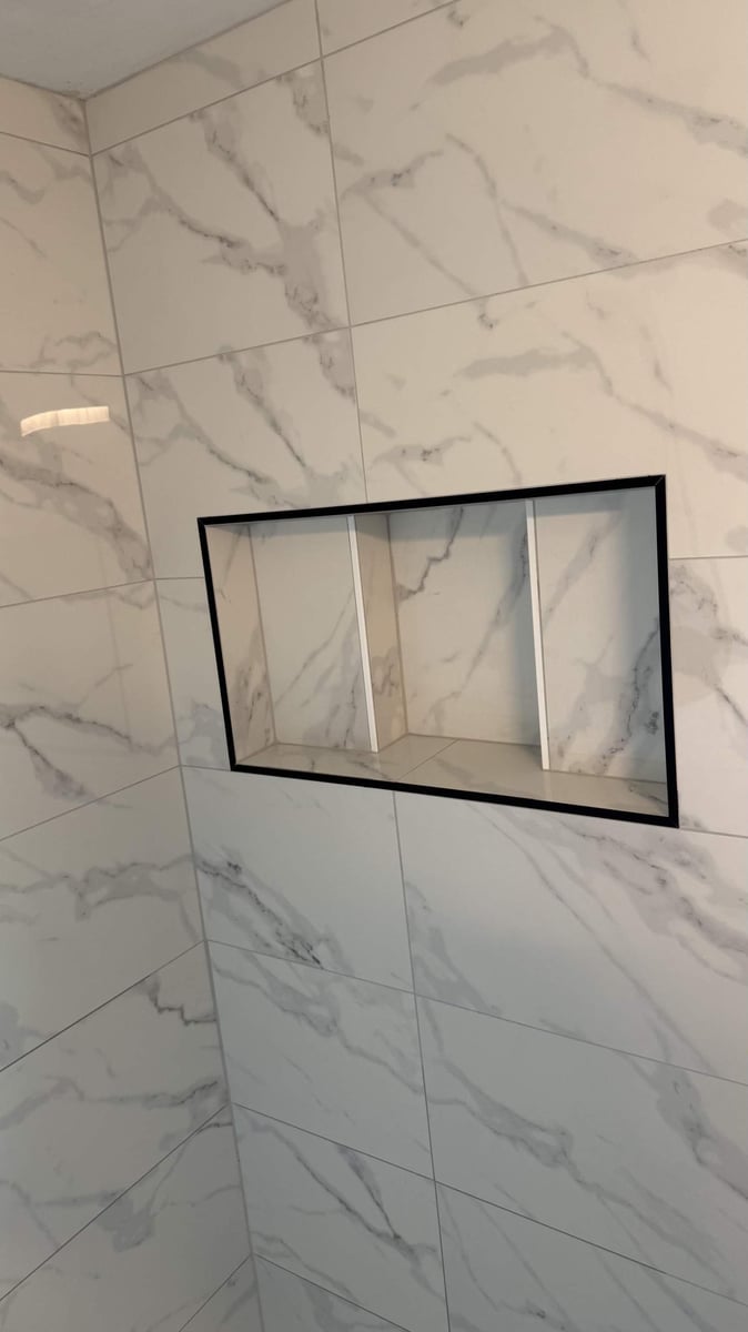 built-in shower shelf with marble-look tile surround by Carolina Signature Custom Homes in Lawrence, NC-optimized