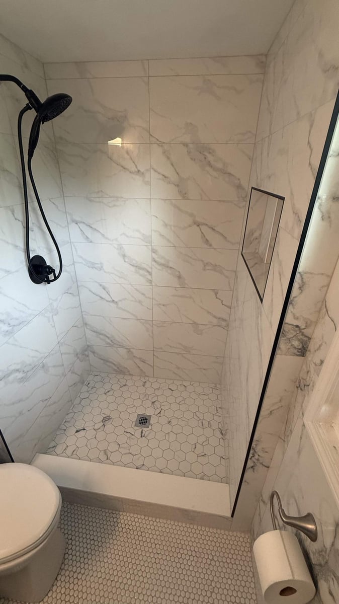 updated bathroom shower with modern tile and fixtures by Carolina Signature Custom Homes in Lawrence, NC-optimized