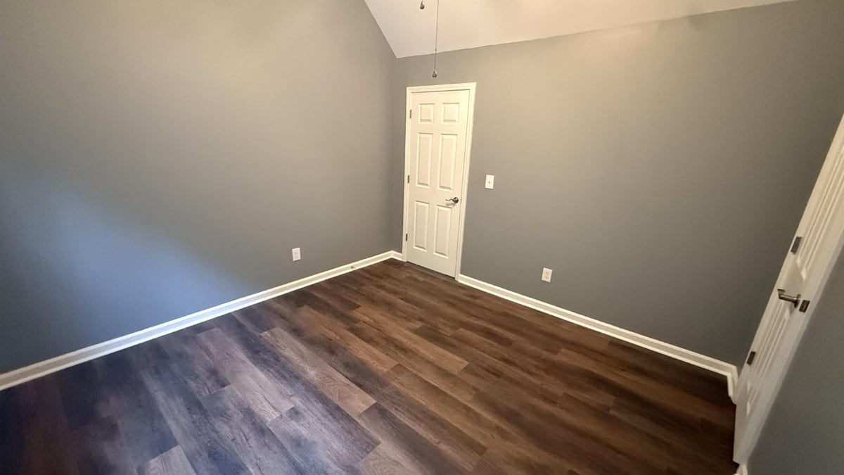 bedroom renovation with new wood flooring and vaulted ceiling in Mooresville NC by Carolina Signature Custom Homes-optimized