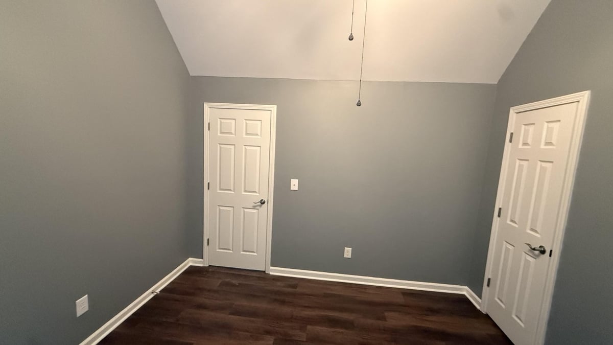 spacious bedroom featuring new wood flooring installation in Mooresville NC by Carolina Signature Custom Homes-optimized