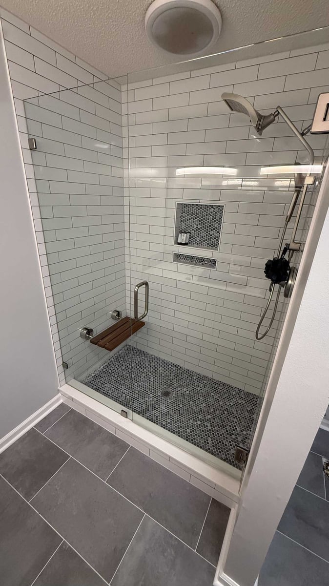modern walk-in shower with subway tile and niche by Carolina Signature Custom Homes in Mooresville, NC-optimized
