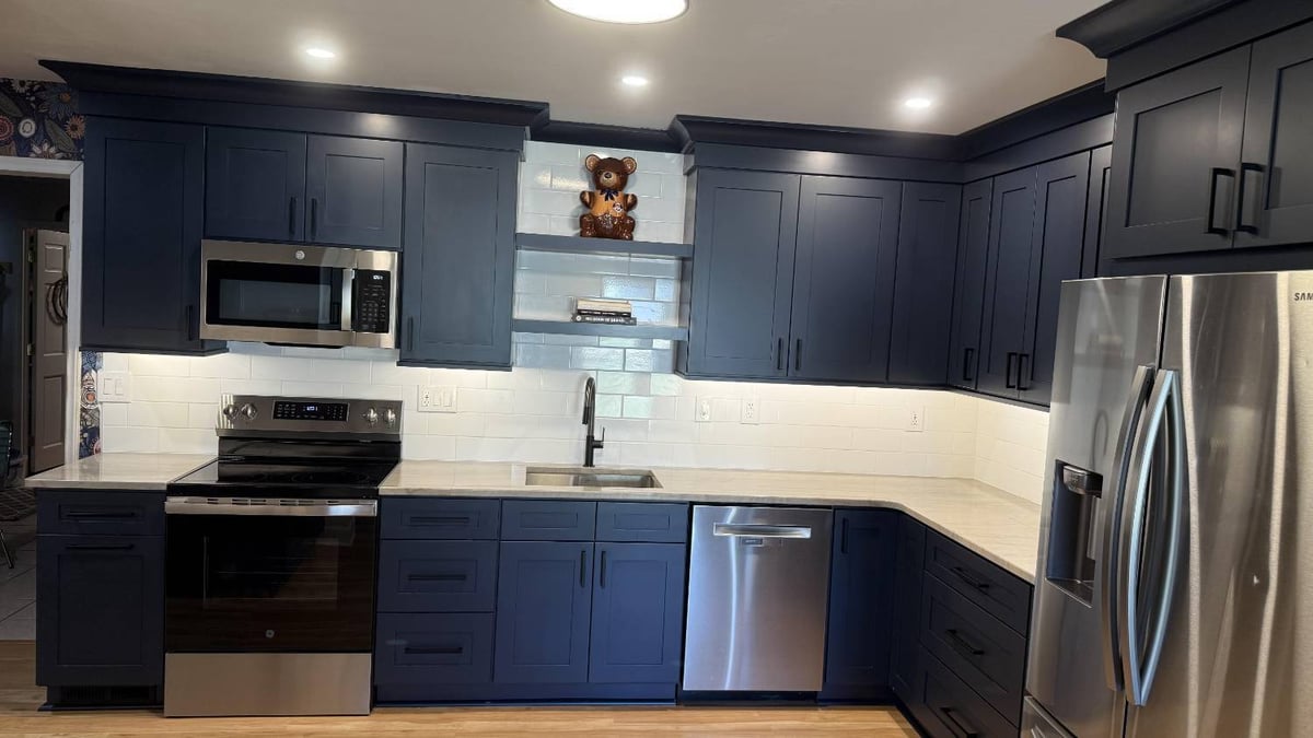 Carolina Signature Custom Homes full kitchen remodel with navy cabinets and stainless steel appliances in Higgins, NC-optimized