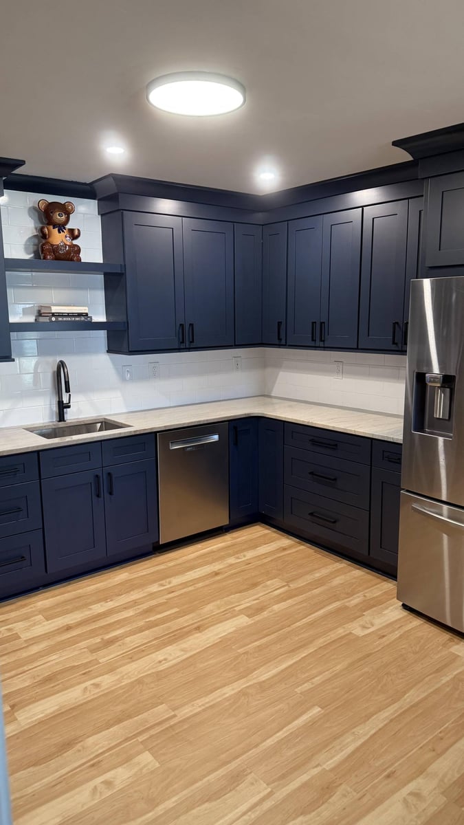 Kitchen corner remodel in Higgins, NC by Carolina Signature Custom Homes with sink area, dishwasher, and dark cabinetry.-optimized