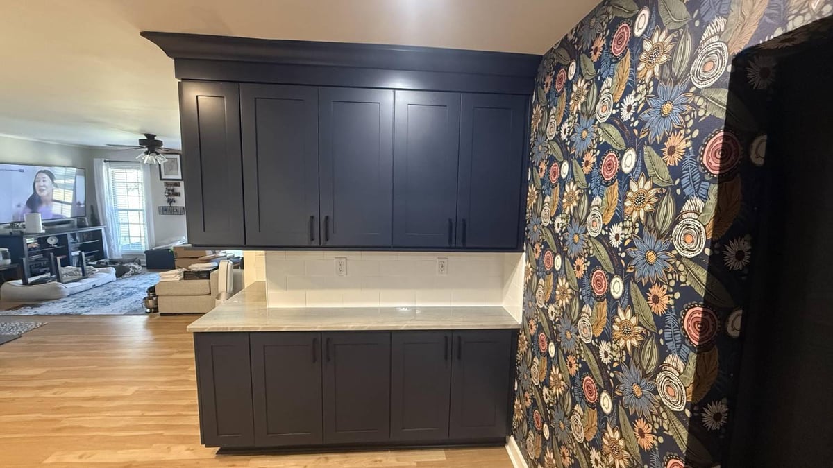 navy kitchen cabinets with built-in storage and patterned wall in Higgins, NC by Carolina Signature Custom Homes-optimized