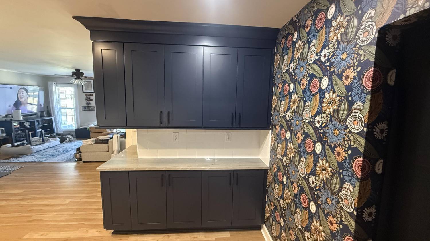 navy kitchen cabinets with built-in storage and patterned wall in Higgins, NC by Carolina Signature Custom Homes navy kitchen cabinets with built-in storage and patterned wall in Higgins, NC by Carolina Signature Custom Homes