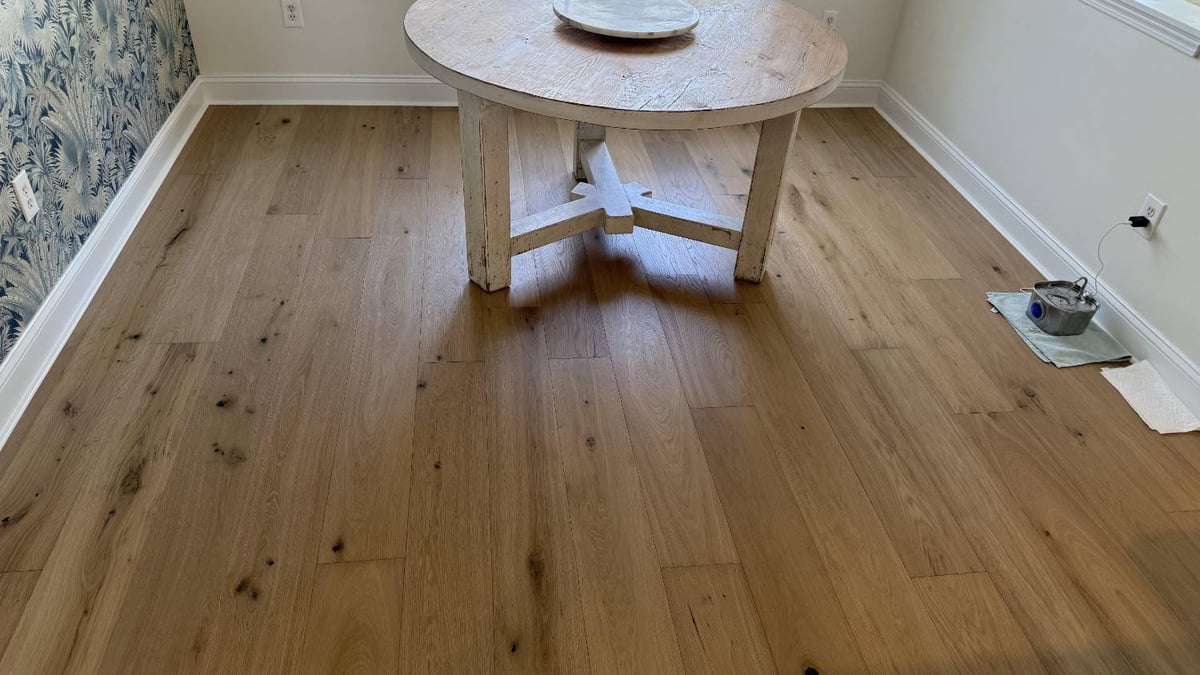 Dining area flooring upgrade in Hutchinson, NC by Carolina Signature Custom Homes with wide plank hardwood and natural grain det-optimized