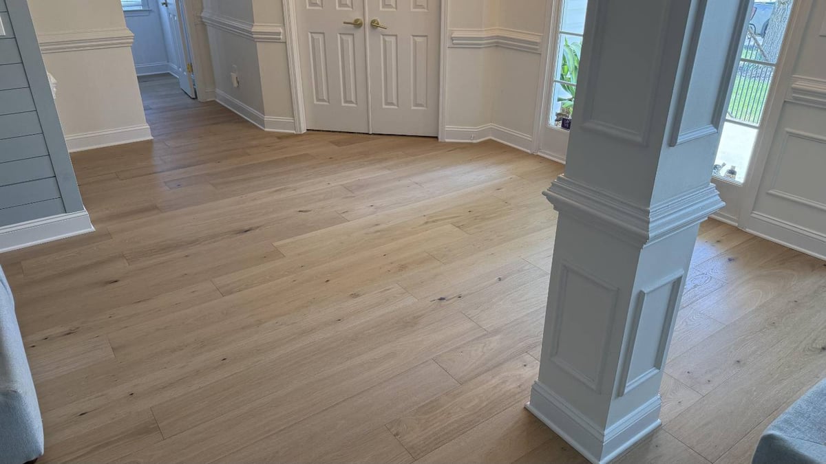 New hardwood flooring installation by Carolina Signature Custom Homes in Hutchinson, NC featuring light oak planks in an open en-optimized
