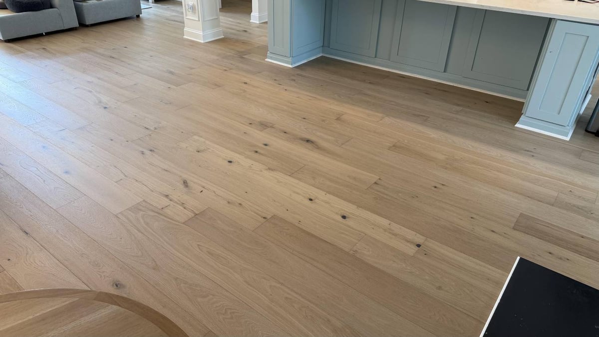 Open living space flooring remodel in Hutchinson, NC by Carolina Signature Custom Homes with wide plank hardwood and airy layout-optimized
