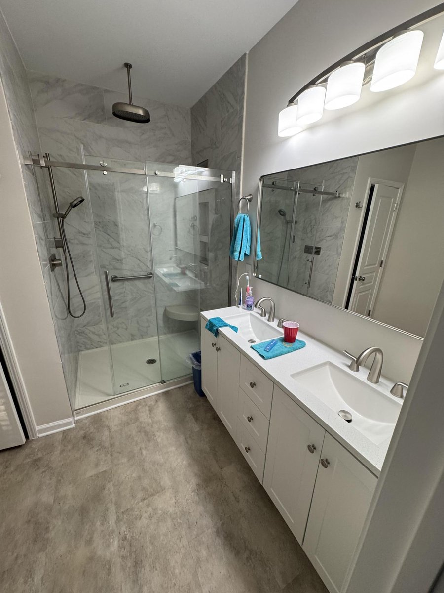bathroom vanity and shower with new flooring, paint, and trim by Carolina Signature Custom Homes in Cornelius, NC-optimized