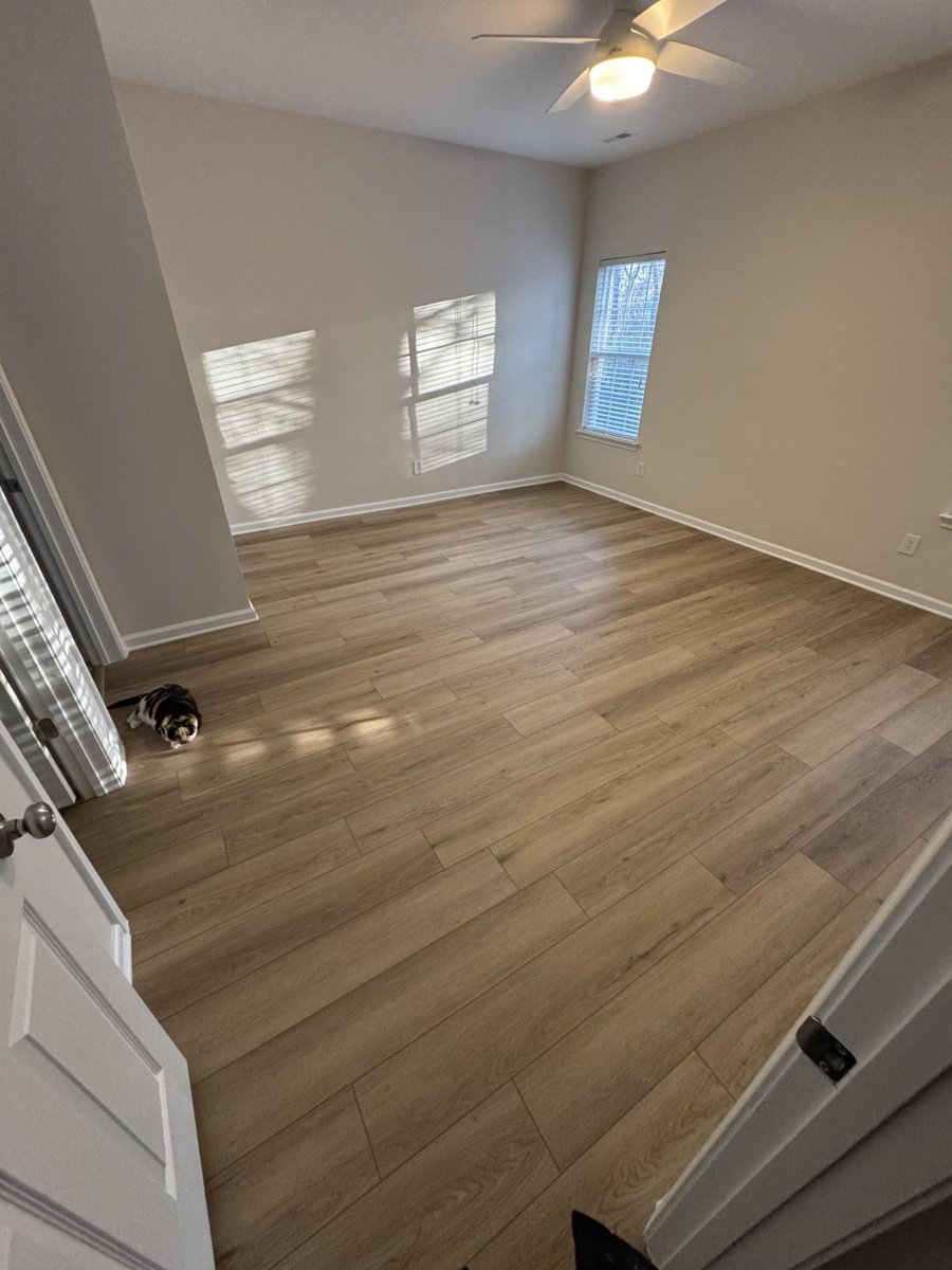 bedroom with natural light and new flooring, paint, and trim by Carolina Signature Custom Homes in Cornelius, NC-optimized
