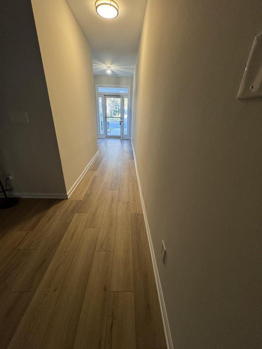 bright hallway leading to entry with updated flooring by Carolina Signature Custom Homes in Cornelius NC-optimized