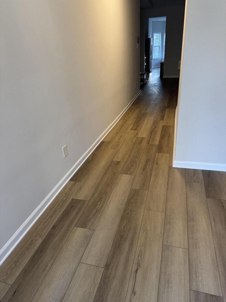 hallway with new wood-look flooring, fresh paint, and trim installed by Carolina Signature Custom Homes in Cornelius, NC-optimized
