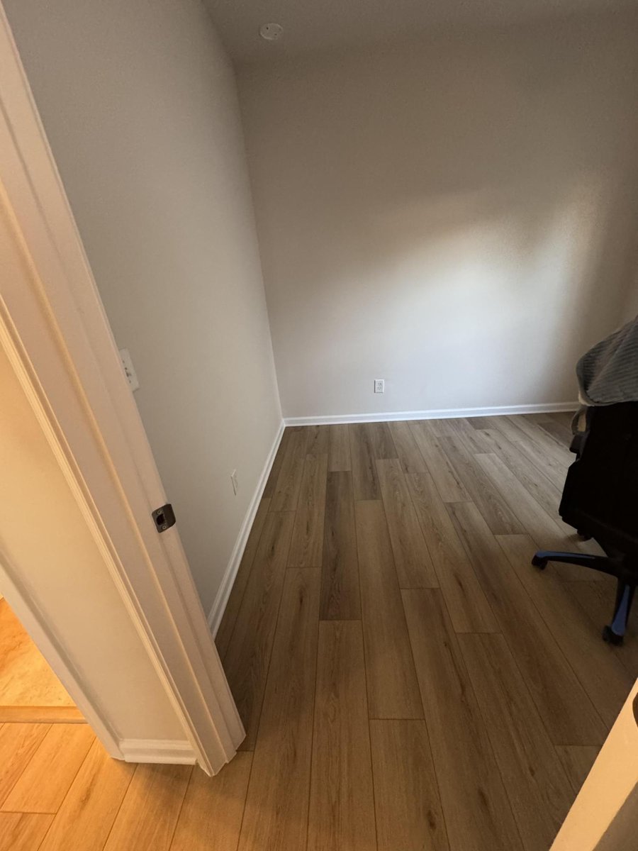 small bedroom with new flooring, fresh paint, and trim by Carolina Signature Custom Homes in Cornelius, NC-optimized