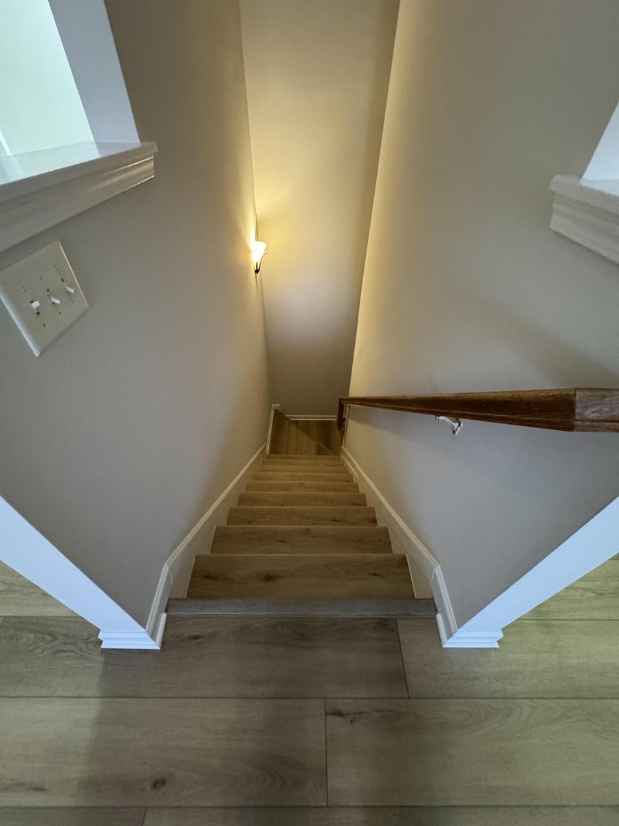 updated stairwell with wood-look flooring and fresh paint by Carolina Signature Custom Homes in Cornelius NC-optimized