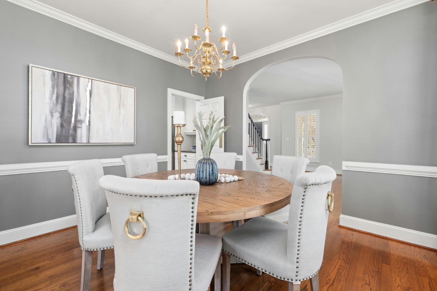 Carolina Signature Custom Homes custom dining room with round wood table and chandelier in Troutman, NC stock-optimized