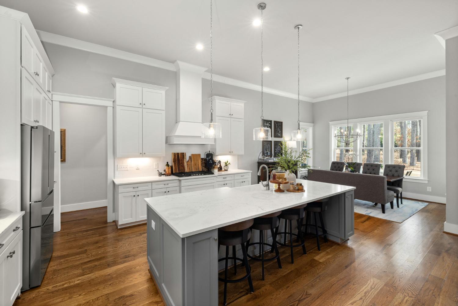 Carolina Signature Custom Homes open kitchen and dining area with large island in Troutman, NC stock-optimized