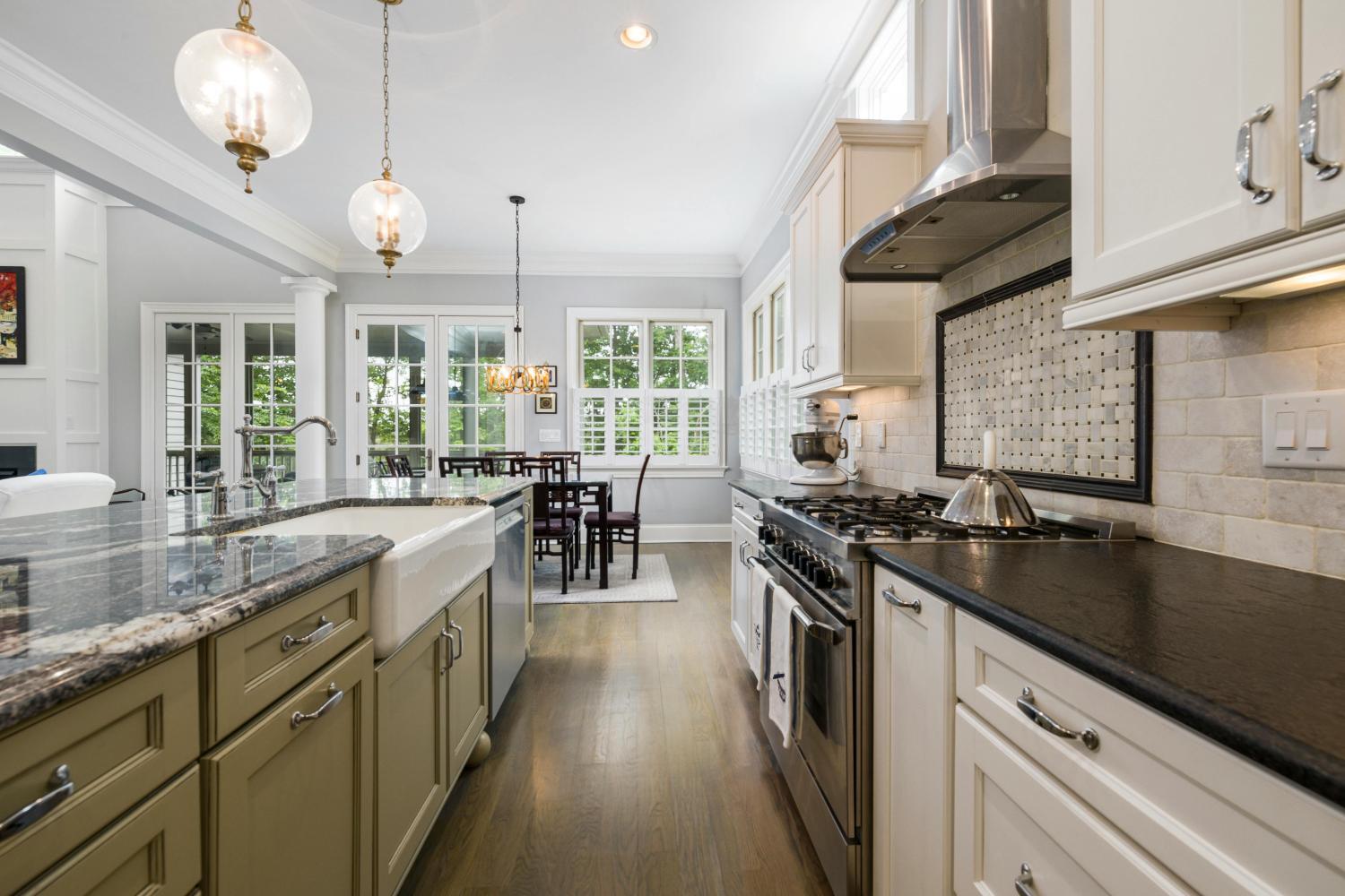 bright custom home kitchen with white cabinetry and stainless range by Carolina Signature Custom Homes Troutman NC stock-optimized
