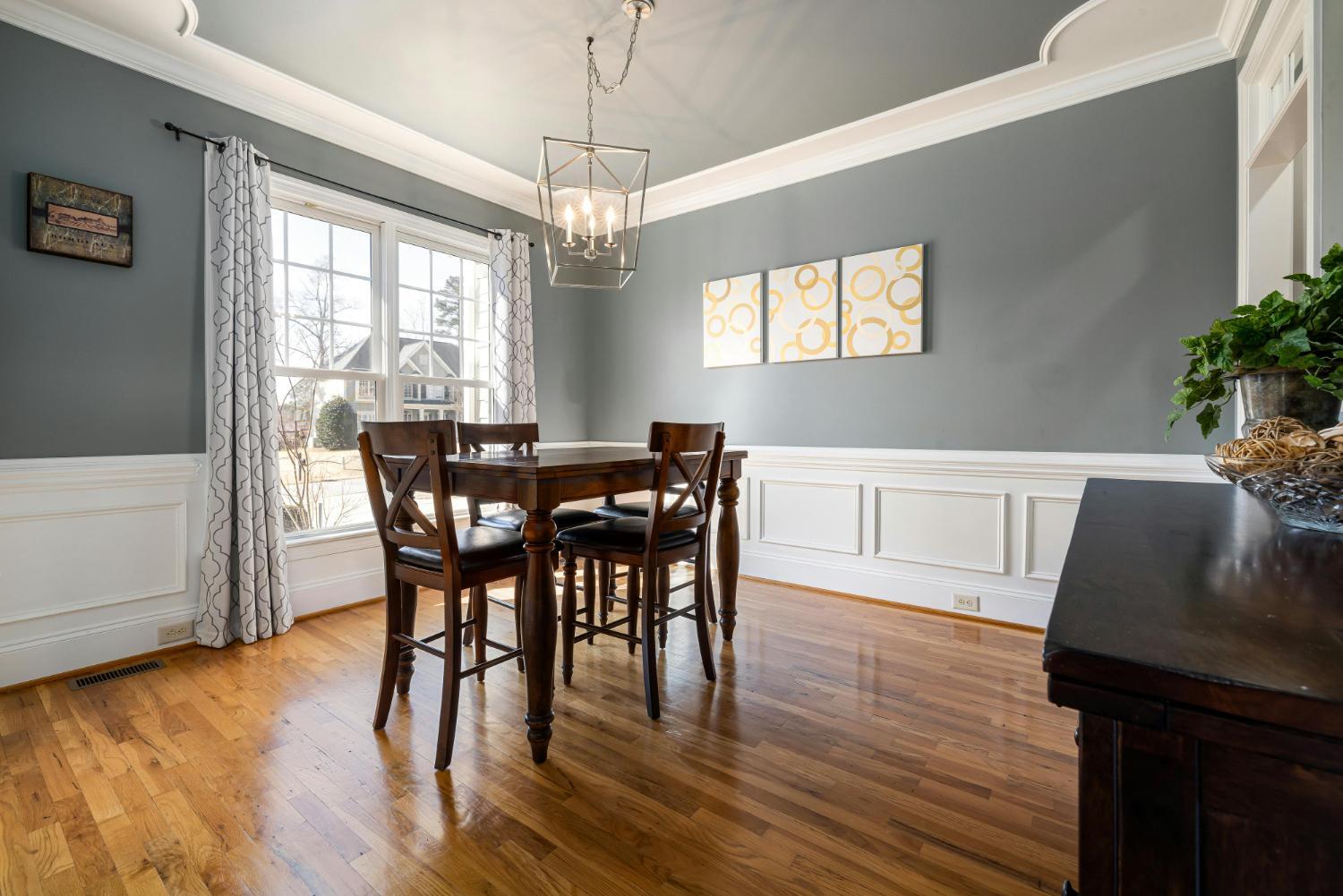 casual dining room in custom home with hardwood floors and large windows by Carolina Signature Custom Homes Troutman NC stock-optimized