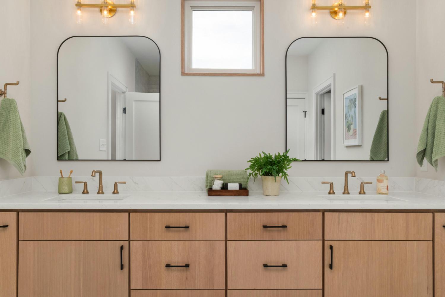 double vanity bathroom with wood cabinetry and modern mirrors in Troutman NC by Carolina Signature Custom Homes stock-optimized