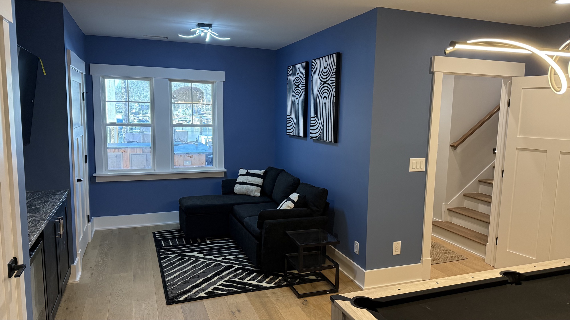 lake norman basement remodel with lounge seating and stairway