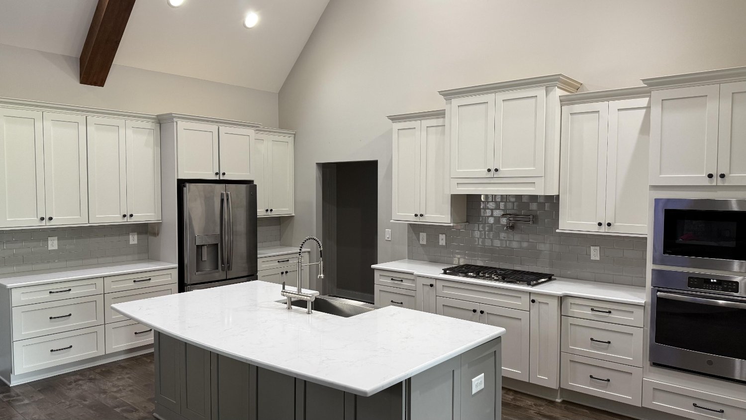 modern custom kitchen with large quartz island and shaker cabinets in Mt Ulla NC by Carolina Signature Custom Homes-optimized