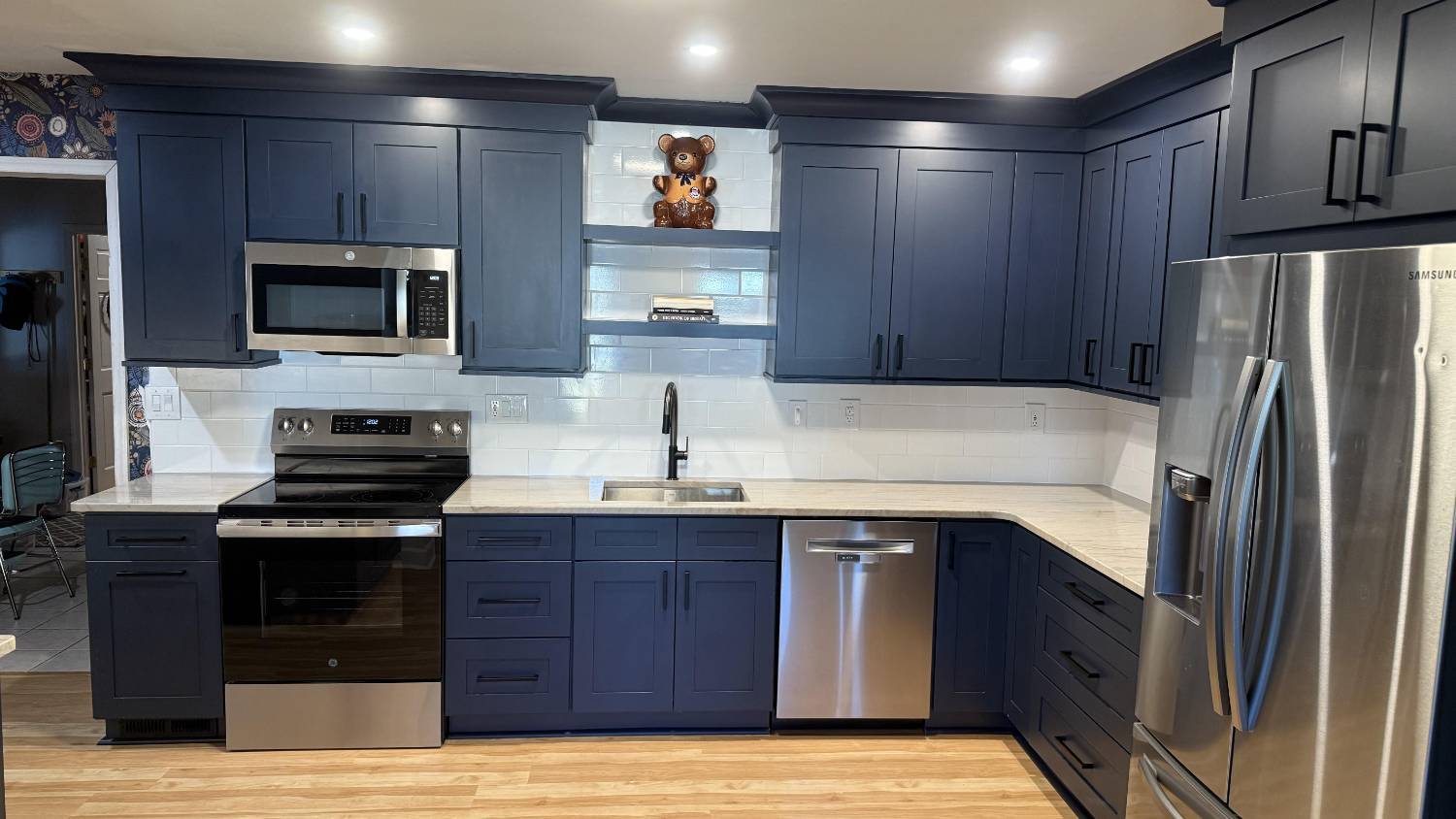 Full kitchen renovation in Higgins, NC by Carolina Signature Custom Homes with stainless steel appliances and expansive cabinetry