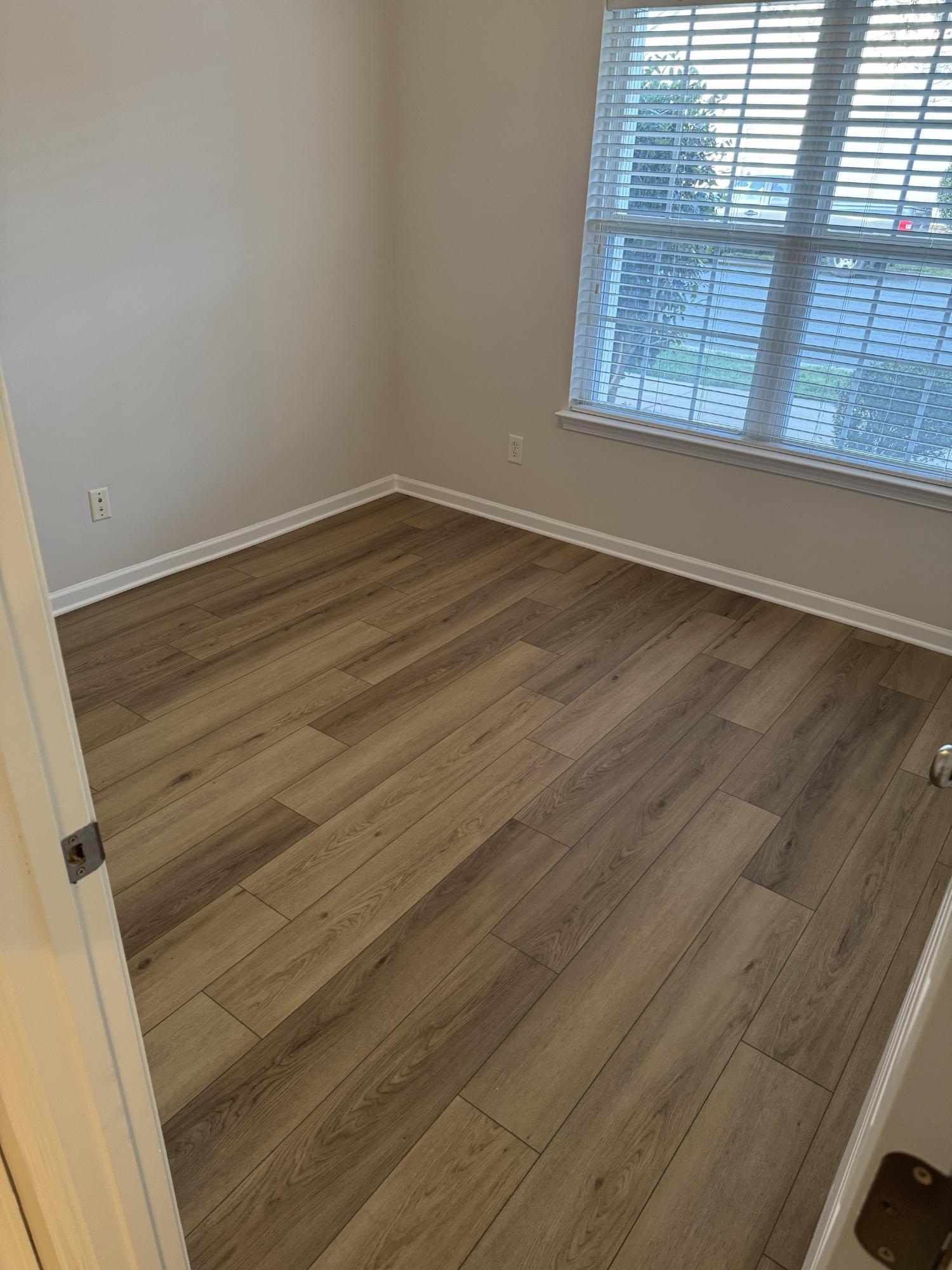 bedroom with new wood flooring, fresh paint, and trim by Carolina Signature Custom Homes in Cornelius, NC-optimized